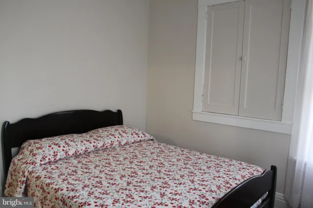 a bedroom with a bed and chair