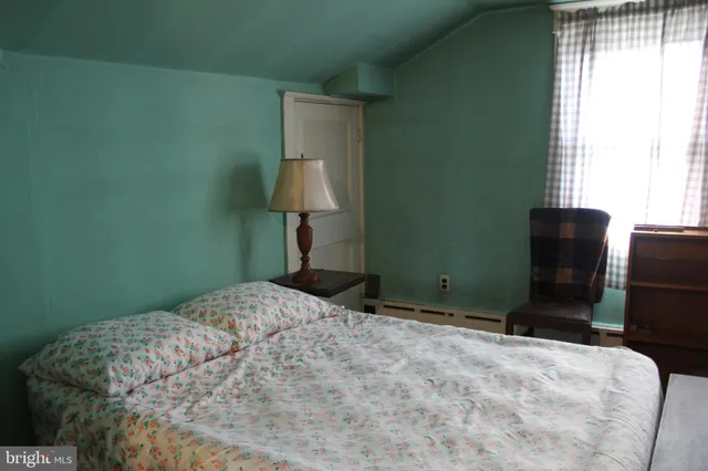 a bedroom with a bed and furniture