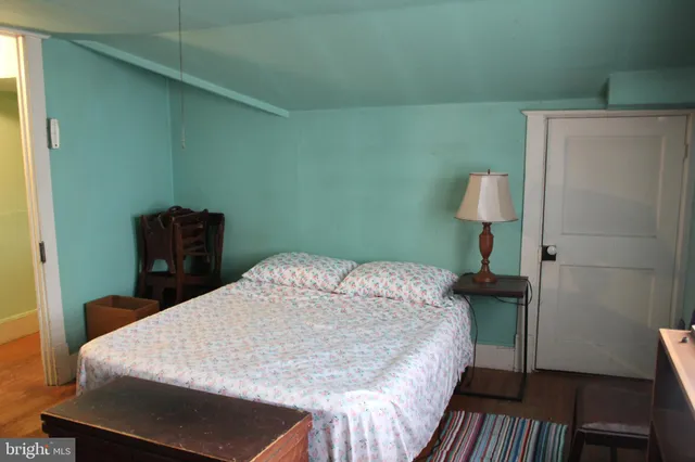 a bedroom with a bed and a lamp on table
