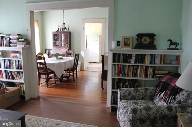 a living room with furniture and a book shelf