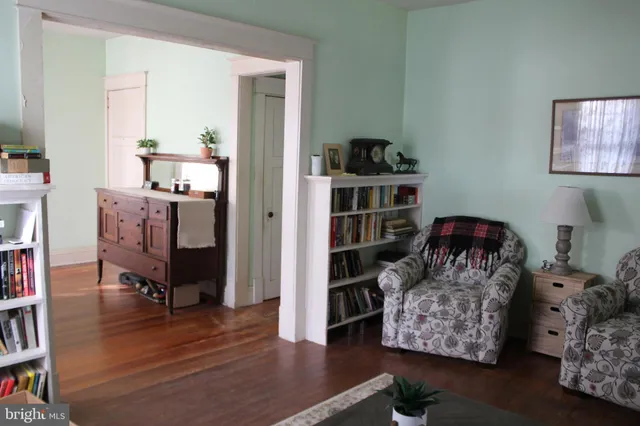 a living room with furniture and a book shelf