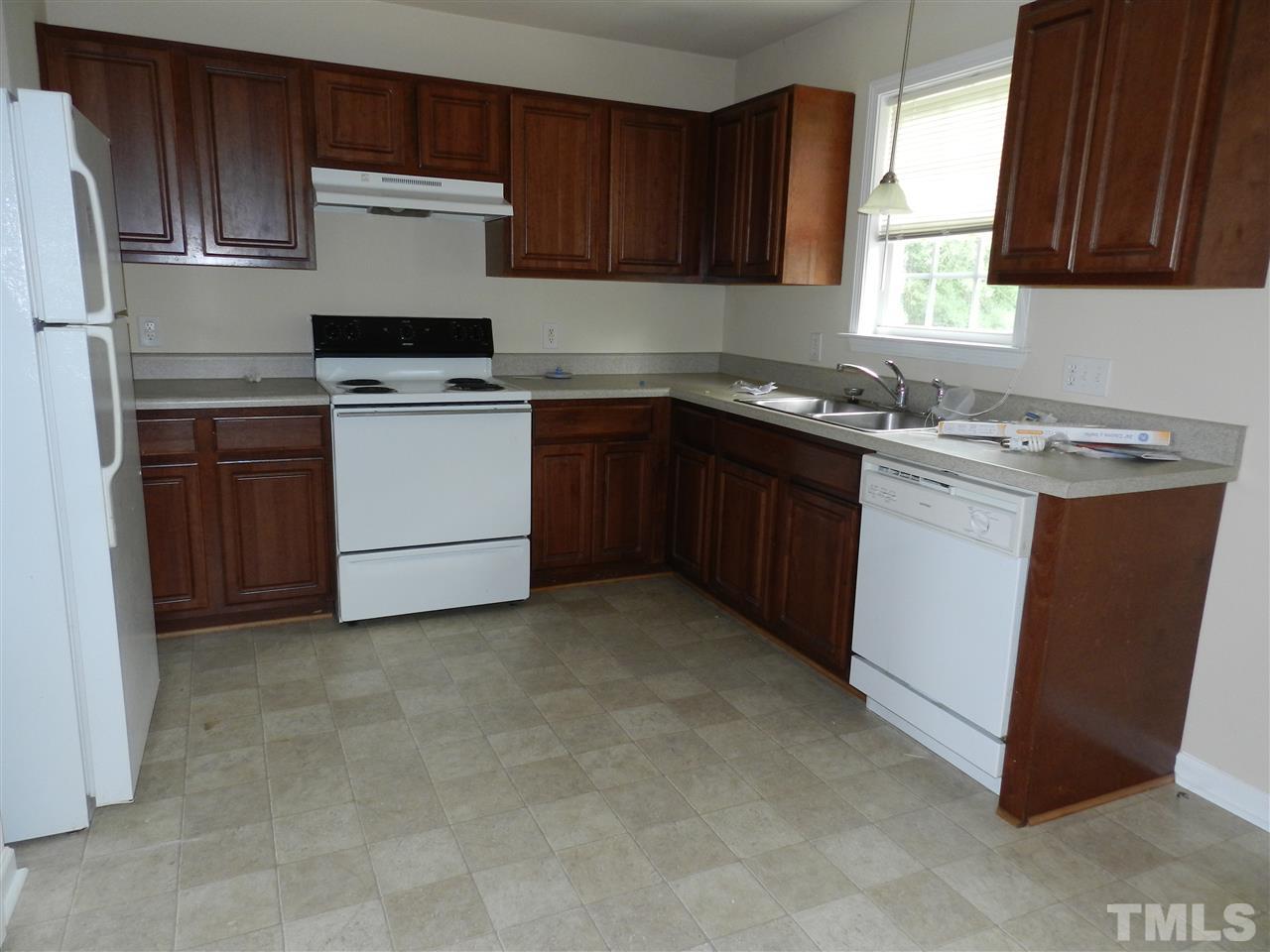 99 Trail Ridge Drive Benson, NC 27504 - Photo 2 of 10 a kitchen with cabinets appliances a sink and a window