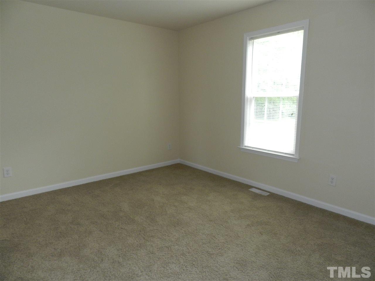 99 Trail Ridge Drive Benson, NC 27504 - Photo 3 of 10 an empty room with a window