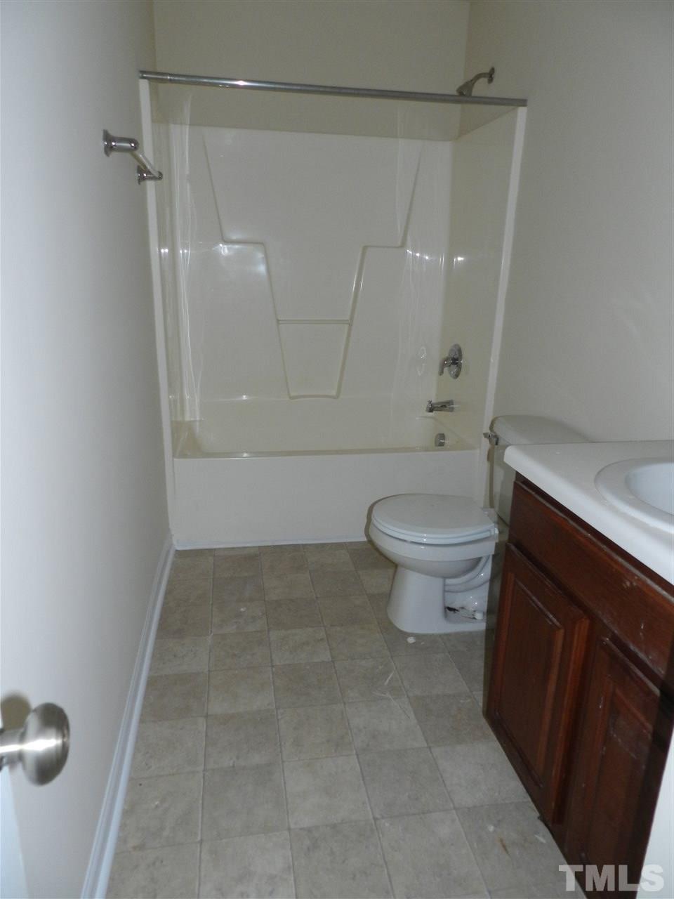 99 Trail Ridge Drive Benson, NC 27504 - Photo 4 of 10 a bathroom with a toilet and a shower