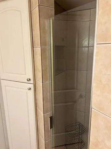 a bathroom with a glass shower door