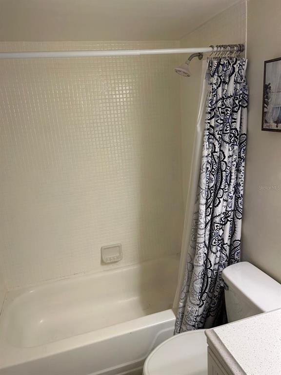 12760 Indian Rocks Road, Unit 1048 Largo, FL 33774 - Photo 16 of 24 a bathroom with a bathtub and shower