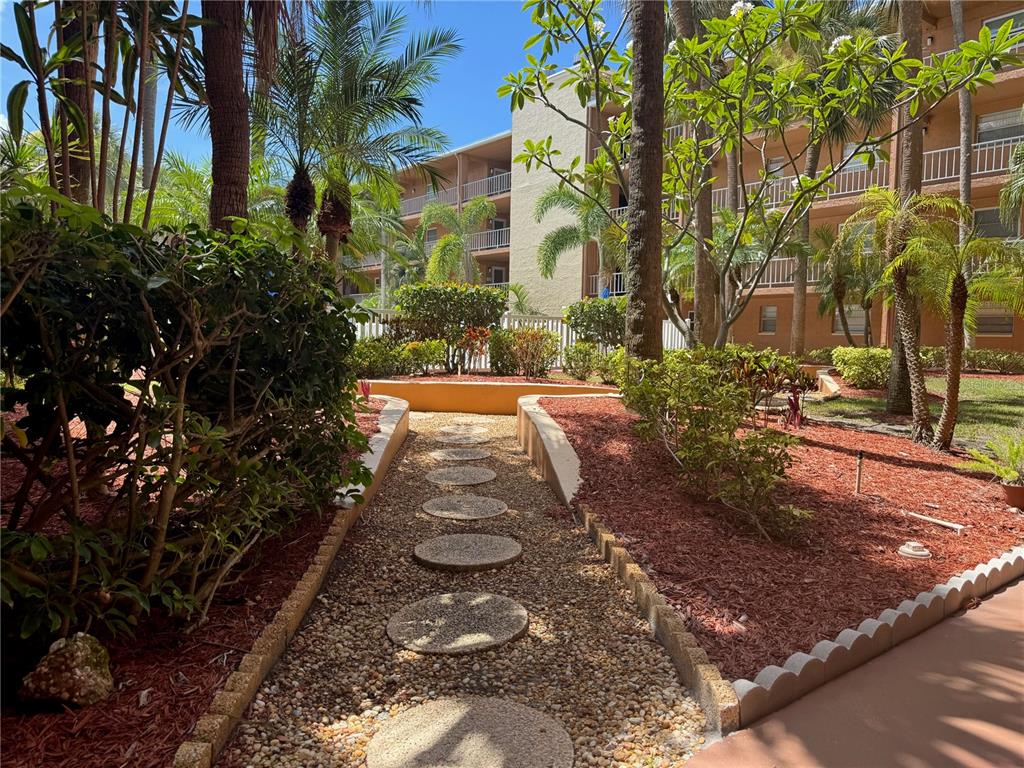 12760 Indian Rocks Road, Unit 1048 Largo, FL 33774 - Photo 18 of 24 a view of a yard with plants and trees