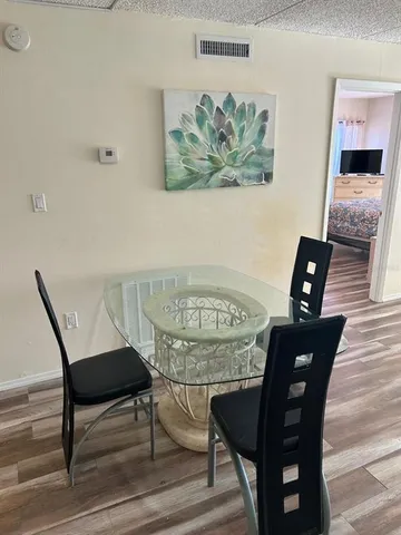 a view of a dining room with furniture and wooden floor