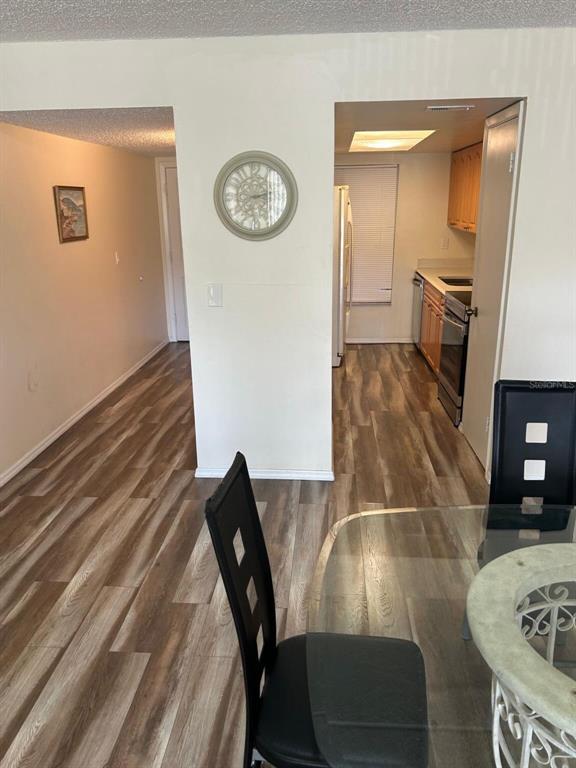 12760 Indian Rocks Road, Unit 1048 Largo, FL 33774 - Photo 7 of 24 a view of a dining room with furniture and wooden floor