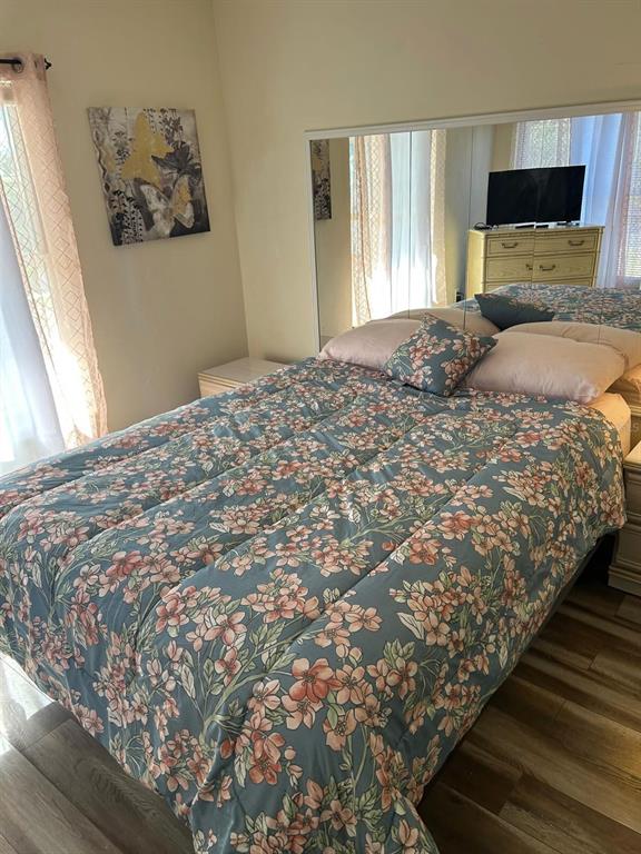 12760 Indian Rocks Road, Unit 1048 Largo, FL 33774 - Photo 10 of 24 a bedroom with a bed and wooden floor