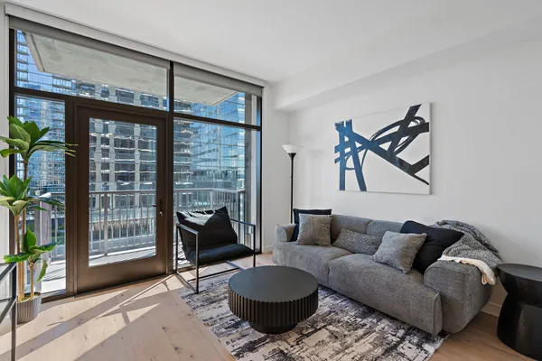 a living room with furniture and a floor to ceiling window