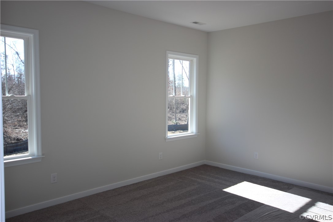 165 New S Ridge Road Bumpass, VA 23024 - Photo 11 of 26 an empty room with wooden floor and windows