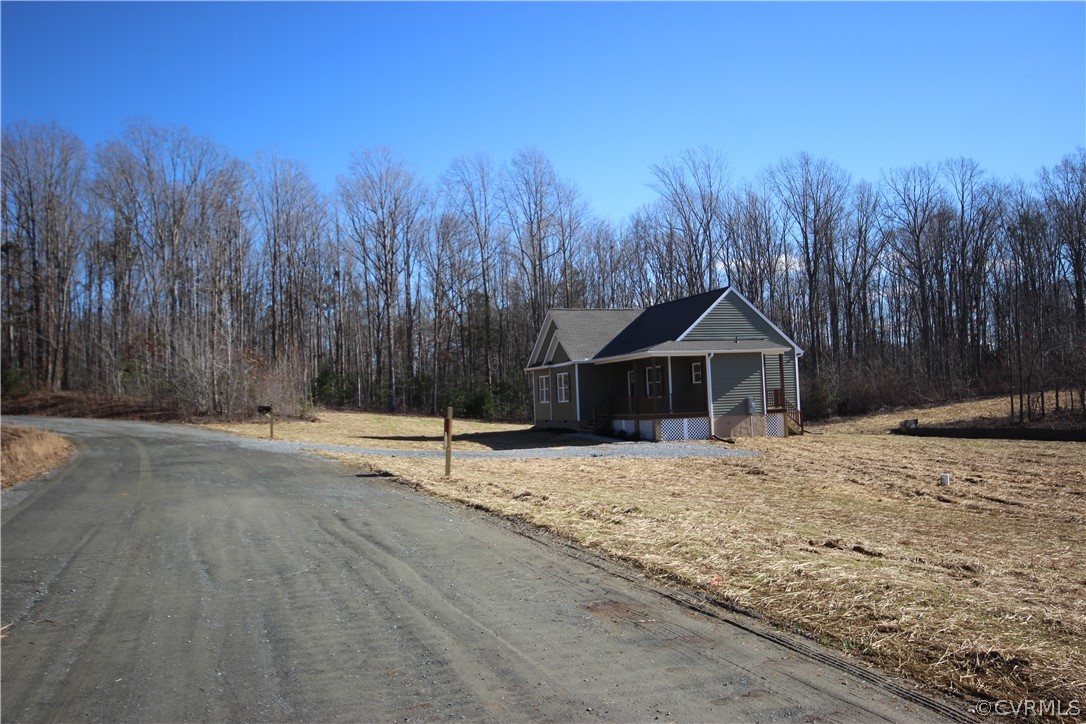 165 New S Ridge Road Bumpass, VA 23024 - Photo 19 of 26 a wooden house with trees in the background