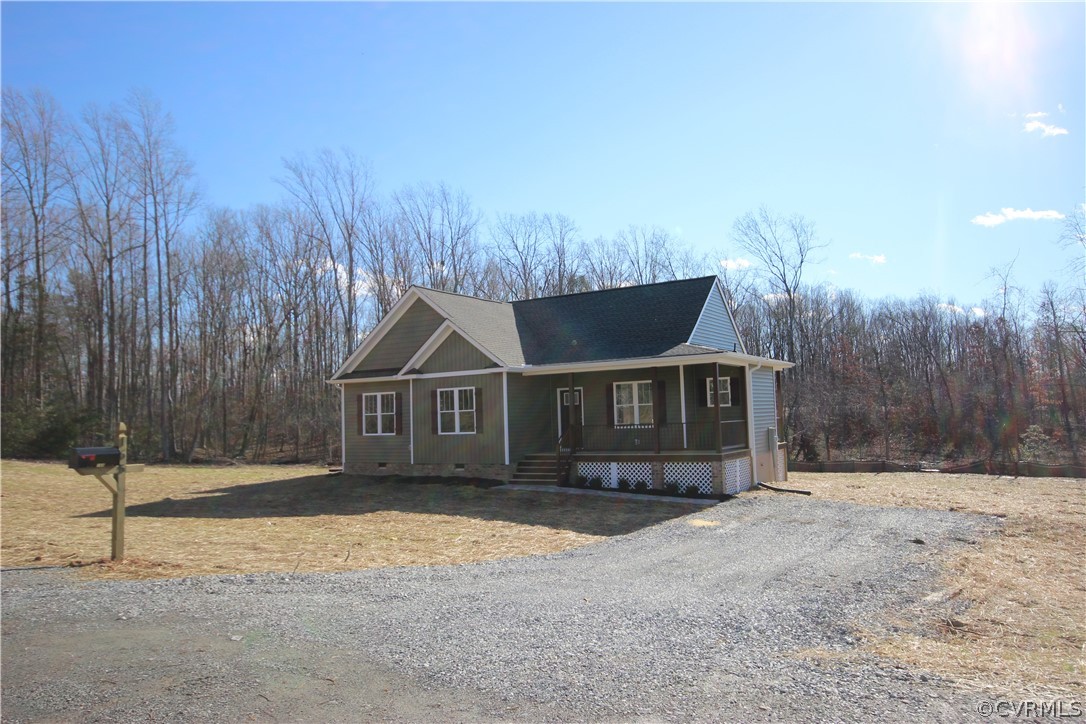 165 New S Ridge Road Bumpass, VA 23024 - Photo 3 of 26 a front view of a house with a yard and garage