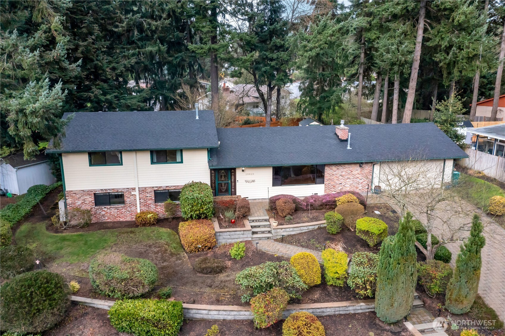 29820 6th Avenue South Federal Way, WA 98003 - Photo 36 of 40 a view of a house with table and chairs under an umbrella