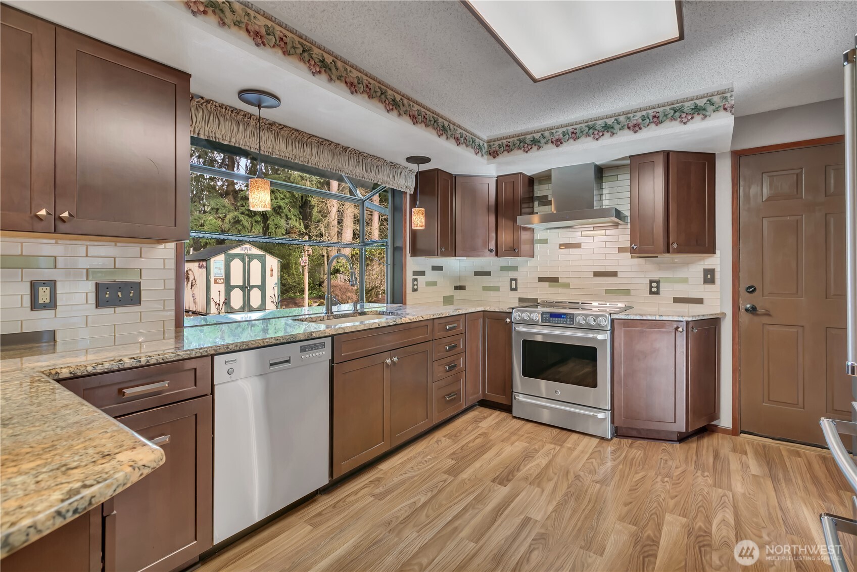 29820 6th Avenue South Federal Way, WA 98003 - Photo 9 of 40 a kitchen with stainless steel appliances granite countertop a stove sink and cabinets