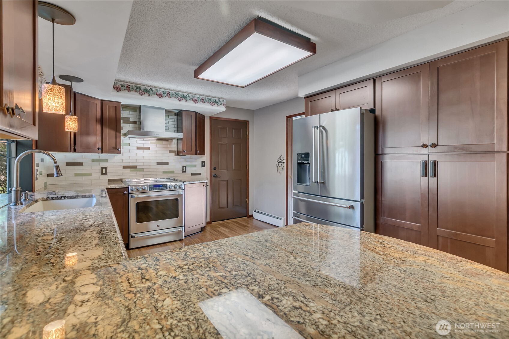 29820 6th Avenue South Federal Way, WA 98003 - Photo 10 of 40 a kitchen with stainless steel appliances granite countertop a refrigerator a stove and a sink