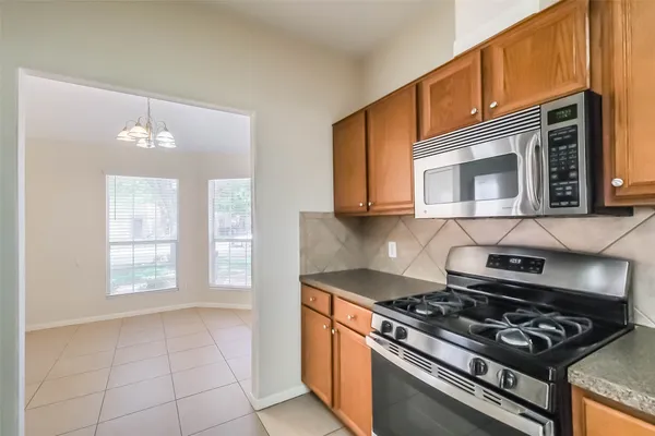 a kitchen with a stove and a microwave
