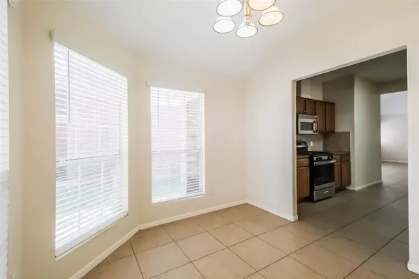 a view of a kitchen with an empty space and a window