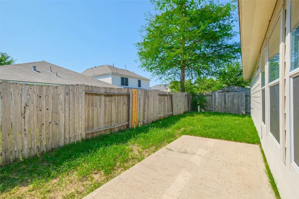 a view of a wooden fence under a large tree