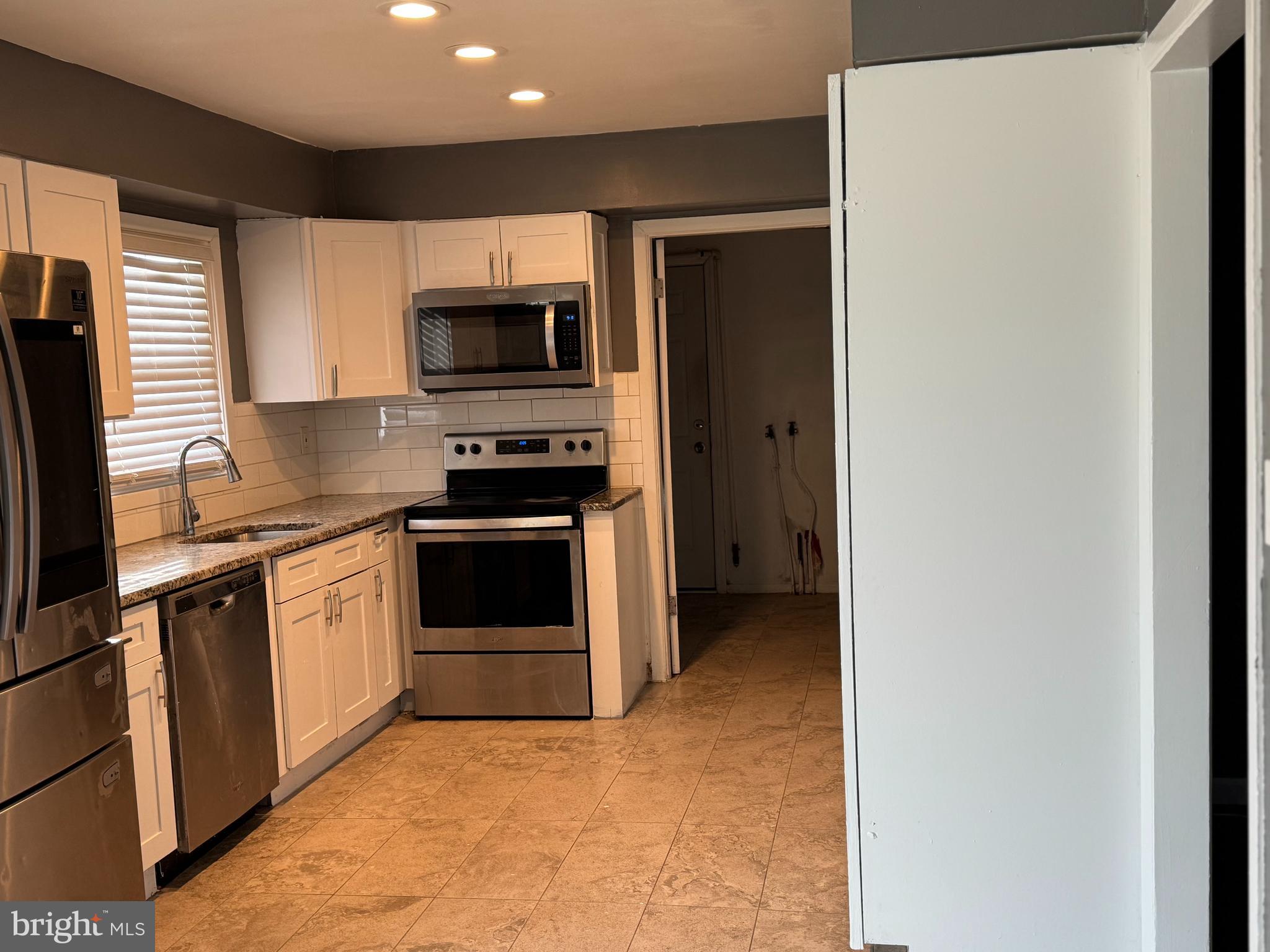 12 Hasting Lane Willingboro, NJ 08046 - Photo 4 of 12 a kitchen with stainless steel appliances a refrigerator stove and microwave