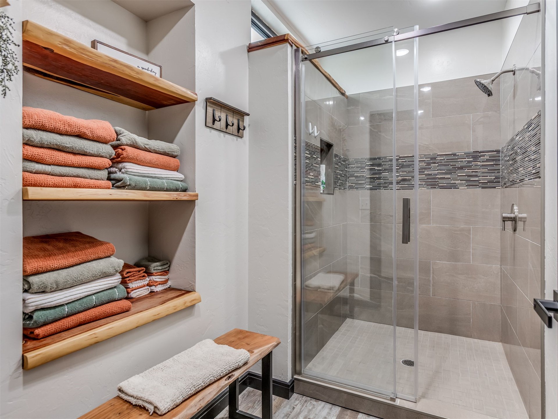 1073 Hidden Ridge Road Stigler, OK 74462 - Photo 43 of 56 Glass-enclosed shower with a tiled bench and a decorative mosaic accent band