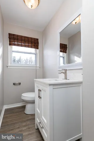 a bathroom with a sink toilet and mirror