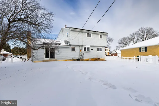a view of a white house with swimming pool
