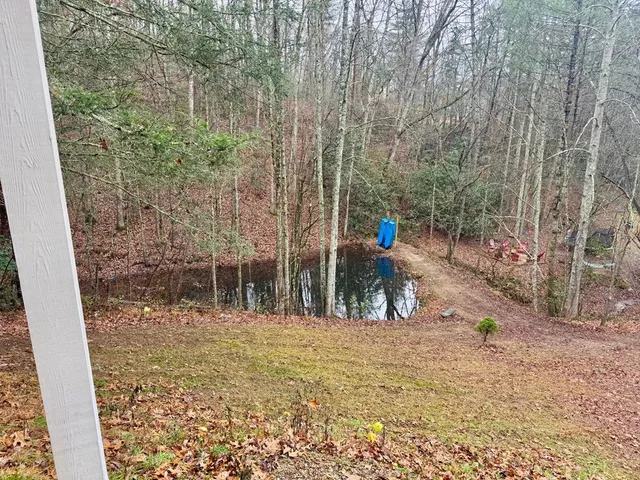 a view of a livingroom with wooden floor and staircase