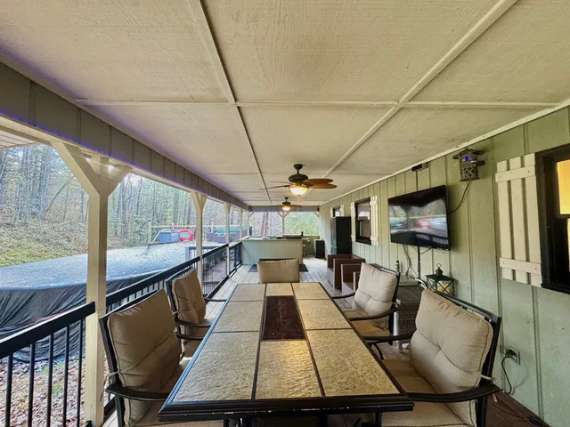 a living room with large window and furniture