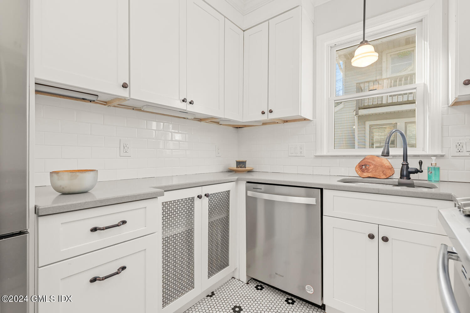 328 Delavan Avenue Greenwich, CT 06830 - Photo 11 of 29 a kitchen with white cabinets and white appliances