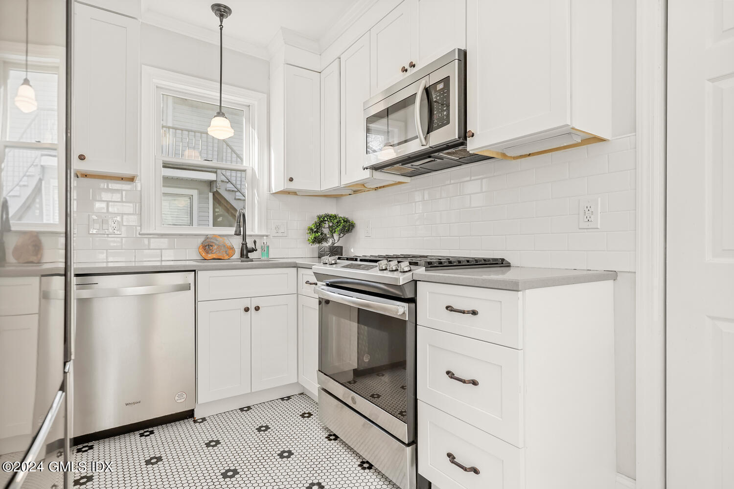 328 Delavan Avenue Greenwich, CT 06830 - Photo 12 of 29 a kitchen with stainless steel appliances white cabinets and a sink