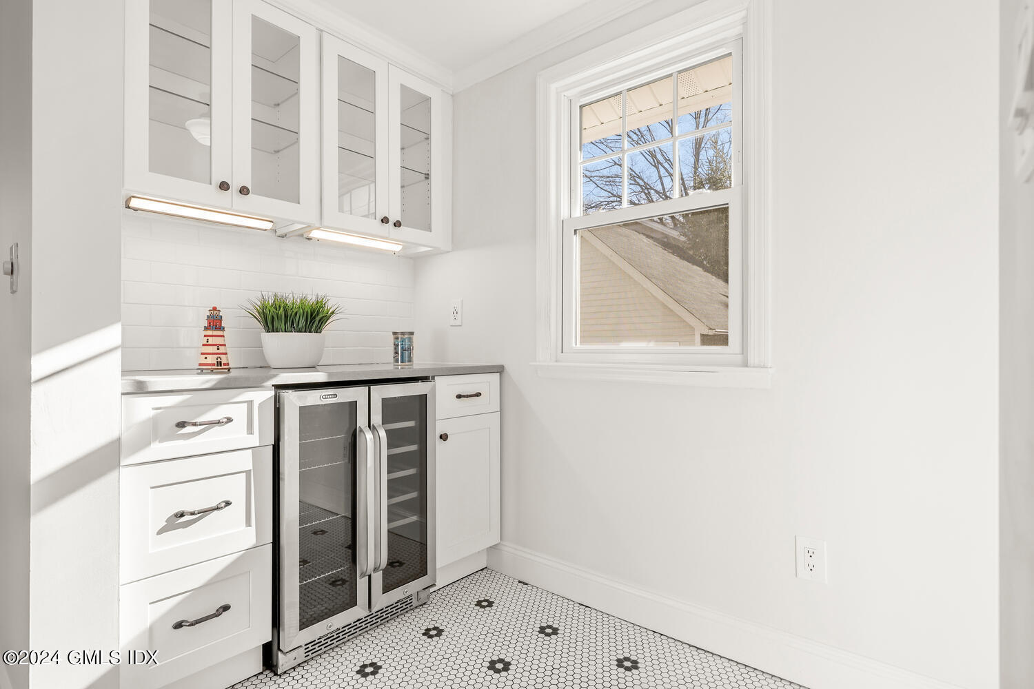 328 Delavan Avenue Greenwich, CT 06830 - Photo 14 of 29 a kitchen with white cabinets and window