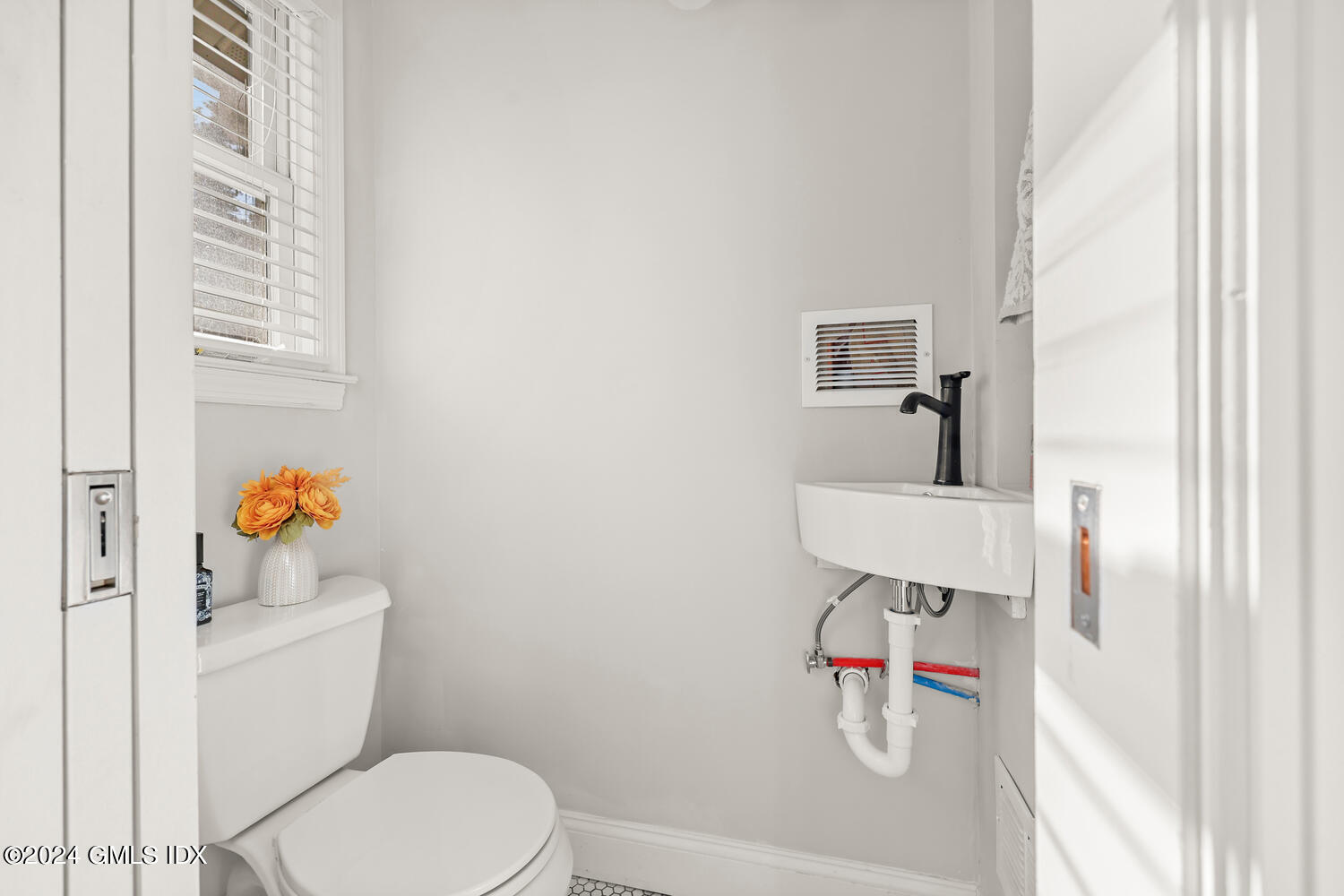 328 Delavan Avenue Greenwich, CT 06830 - Photo 17 of 29 a bathroom with a white toilet and a shower curtain