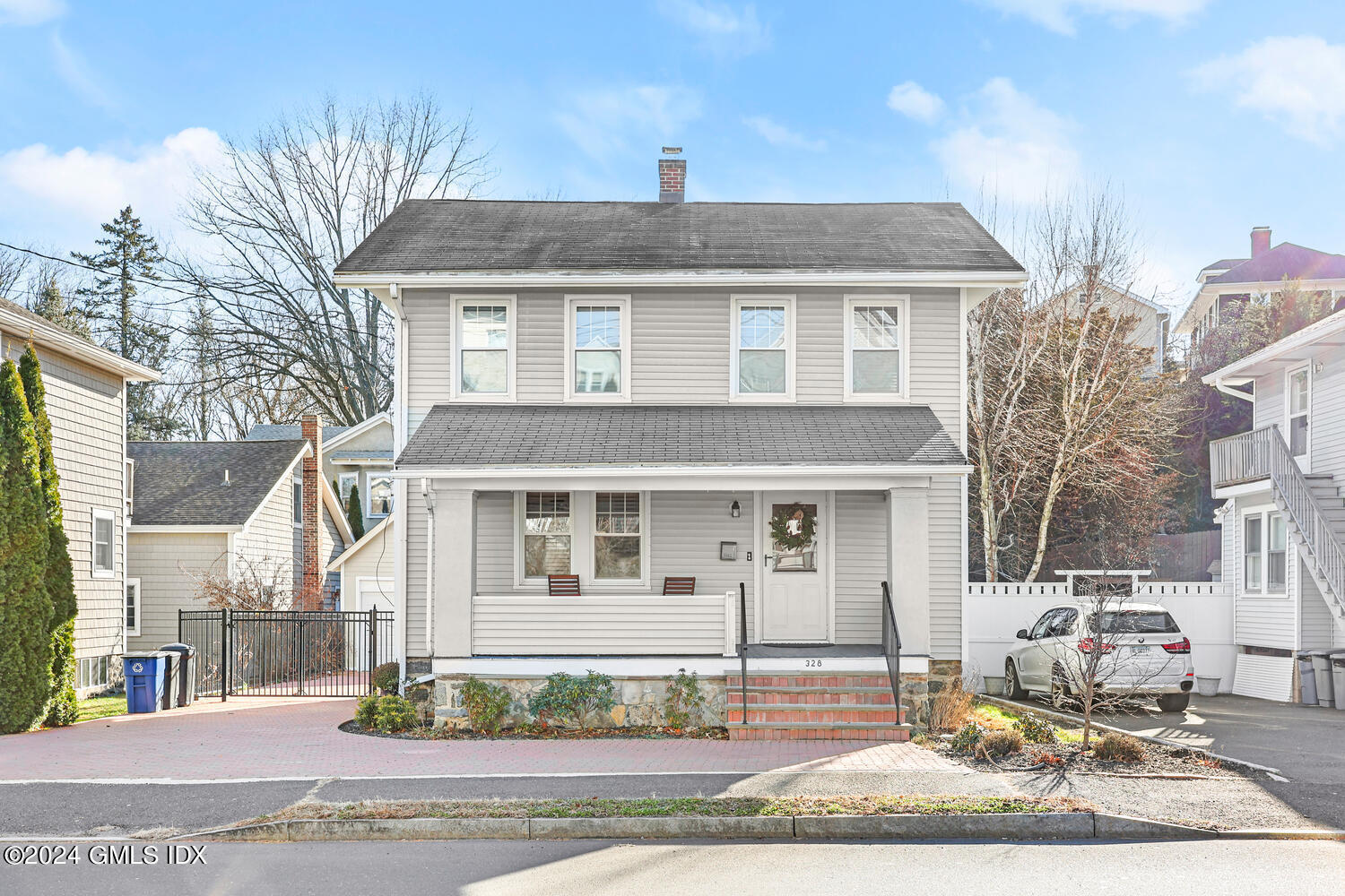 328 Delavan Avenue Greenwich, CT 06830 - Photo 2 of 29 a front view of a house with a yard