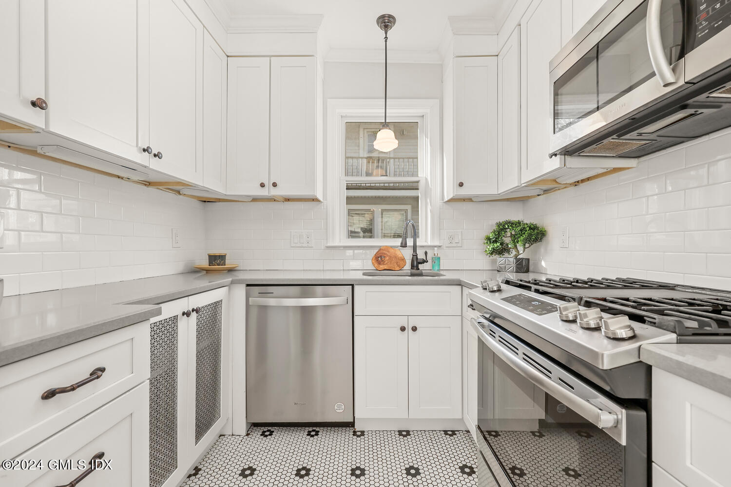 328 Delavan Avenue Greenwich, CT 06830 - Photo 10 of 29 a kitchen with cabinets appliances and a sink