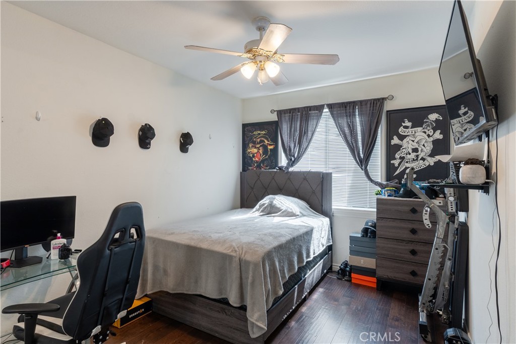 3807 Seattle Street Hemet, CA 92545 - Photo 13 of 37 a bedroom with a bed and a chandelier