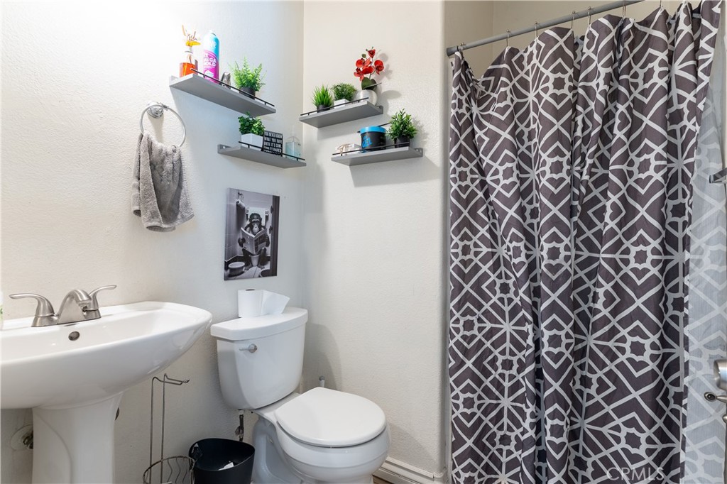 3807 Seattle Street Hemet, CA 92545 - Photo 14 of 37 a bathroom with a sink toilet and a mirror
