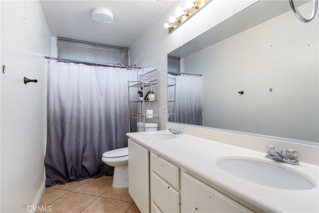 3807 Seattle Street Hemet, CA 92545 - Photo 15 of 37 a bathroom with a sink a toilet and shower