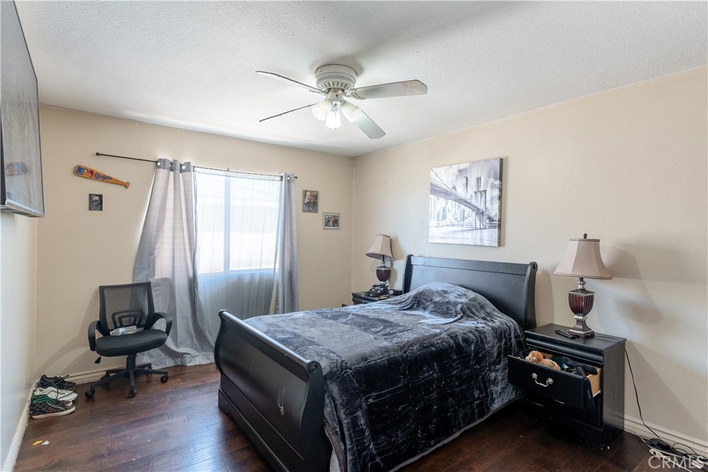 3807 Seattle Street Hemet, CA 92545 - Photo 16 of 37 a bedroom with a bed and a chandelier