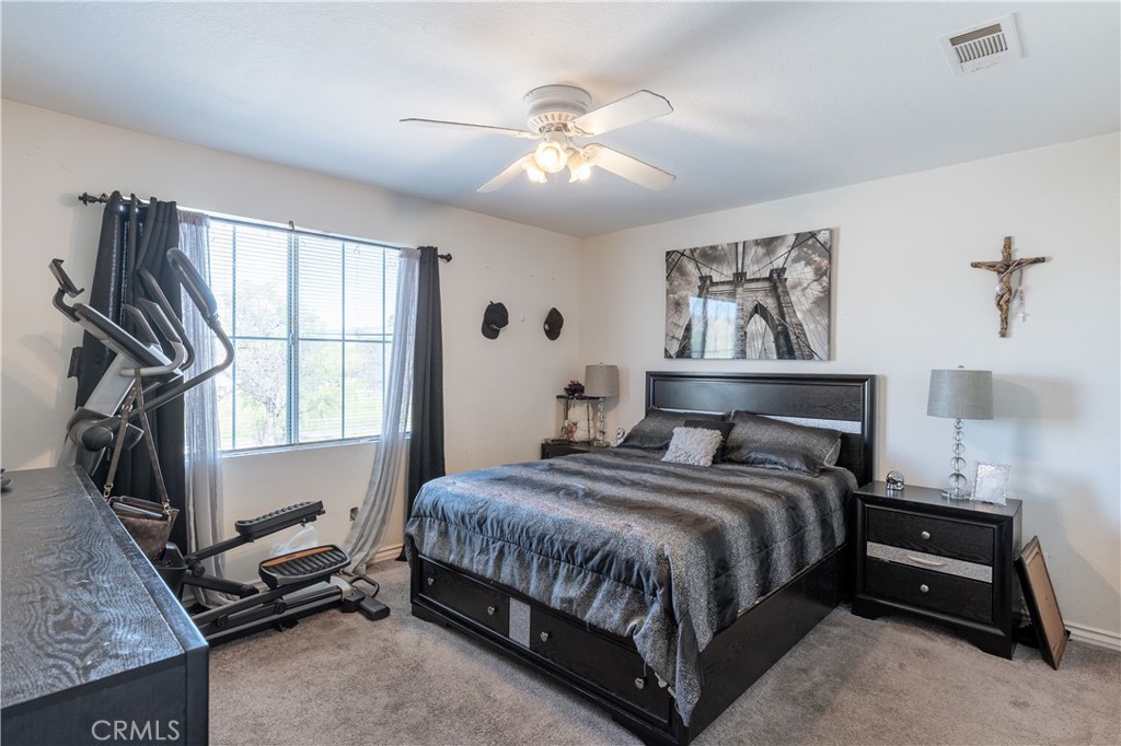 3807 Seattle Street Hemet, CA 92545 - Photo 18 of 37 a bedroom with a bed a couch and dresser