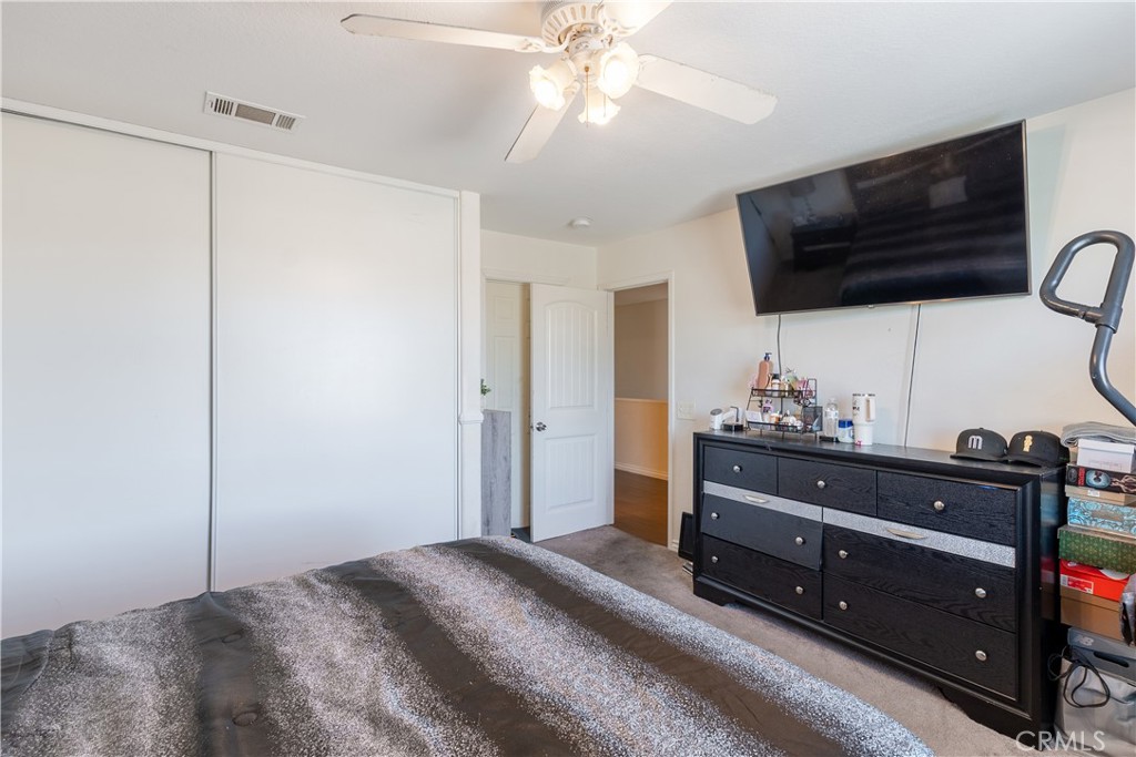 3807 Seattle Street Hemet, CA 92545 - Photo 19 of 37 a bedroom with a bed and a flat tv screen