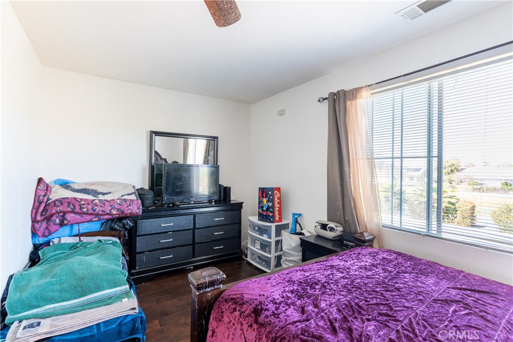 3807 Seattle Street Hemet, CA 92545 - Photo 21 of 37 a bedroom with a bed closet and window