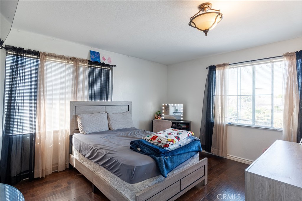 3807 Seattle Street Hemet, CA 92545 - Photo 22 of 37 a bedroom with a bed and wooden floor