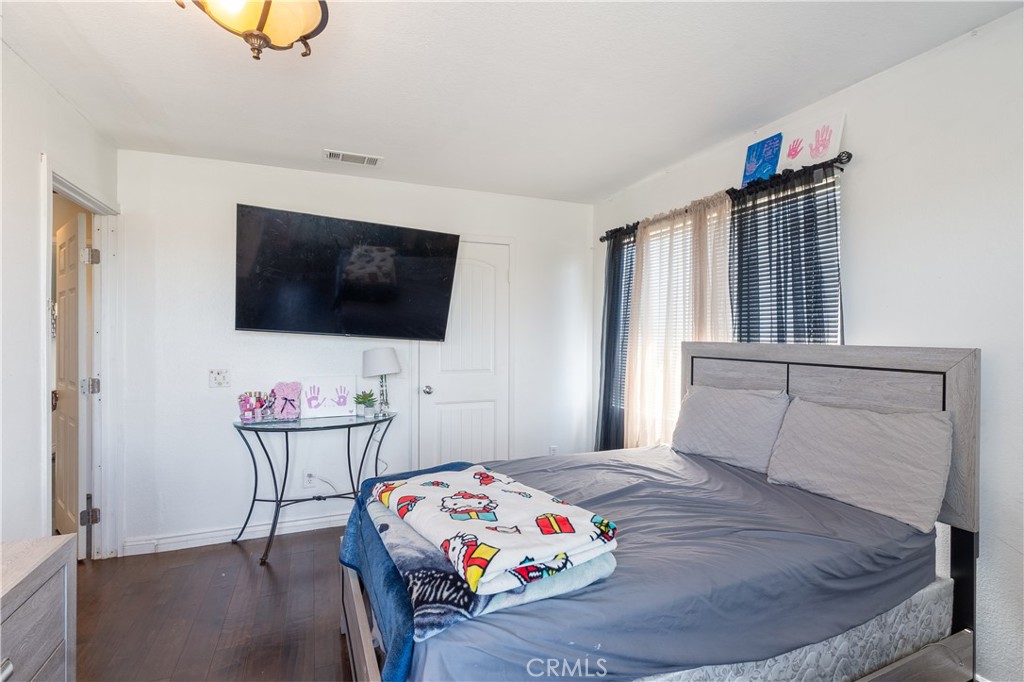 3807 Seattle Street Hemet, CA 92545 - Photo 23 of 37 a bedroom with a bed and a flat screen tv