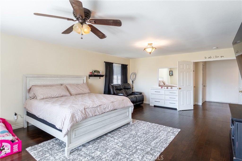 3807 Seattle Street Hemet, CA 92545 - Photo 25 of 37 a spacious bedroom with a bed and a dresser
