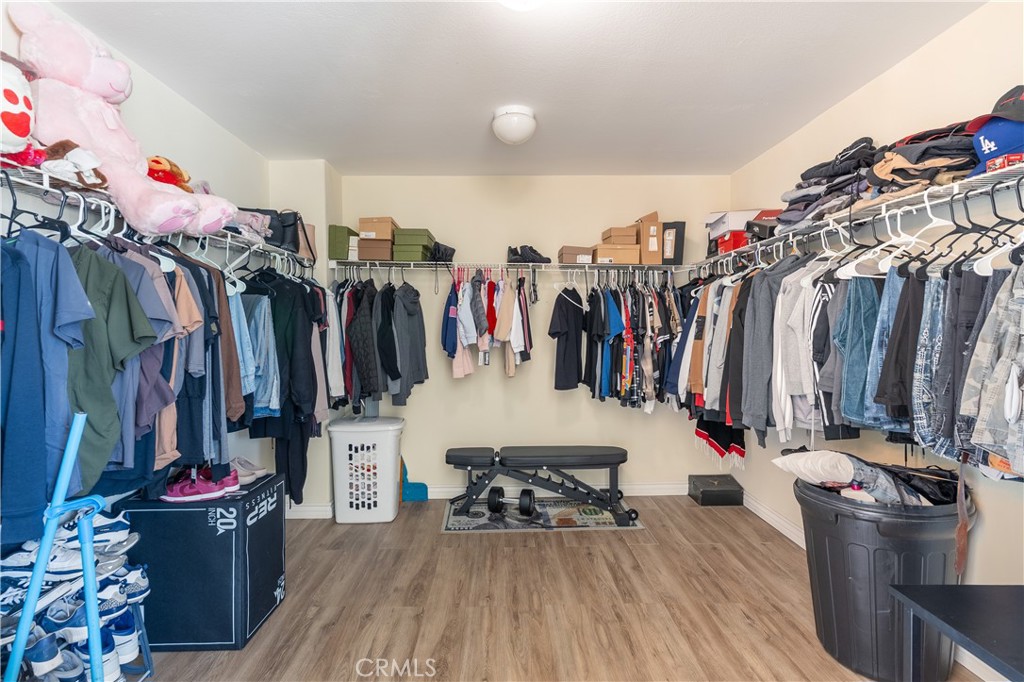 3807 Seattle Street Hemet, CA 92545 - Photo 26 of 37 a walk in closet with clothes and shoes