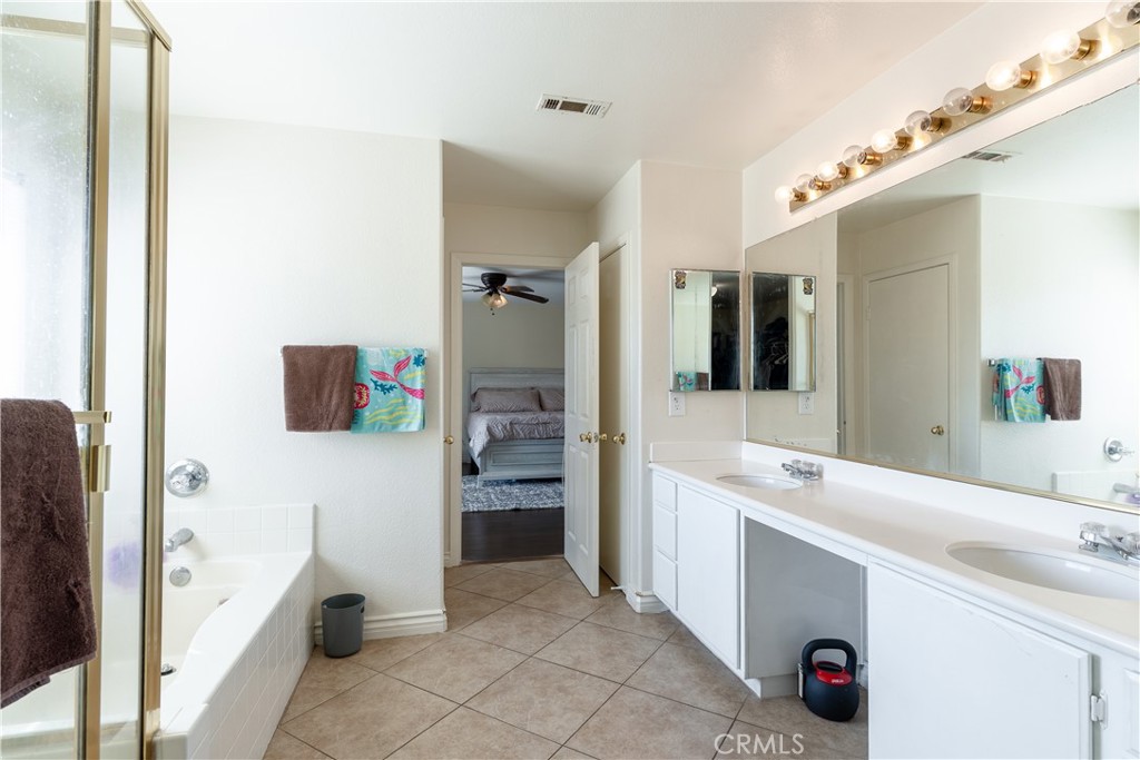 3807 Seattle Street Hemet, CA 92545 - Photo 27 of 37 a spacious bathroom with a sink mirror and shower