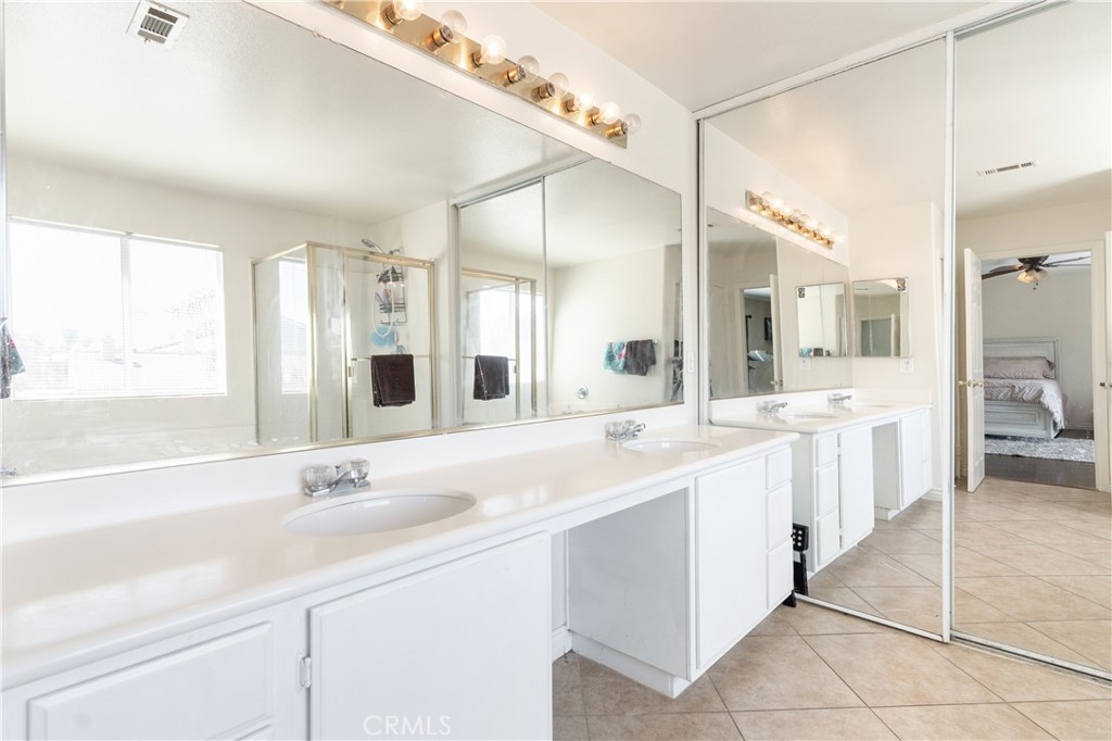 3807 Seattle Street Hemet, CA 92545 - Photo 28 of 37 a large bathroom with a double vanity sink mirror and