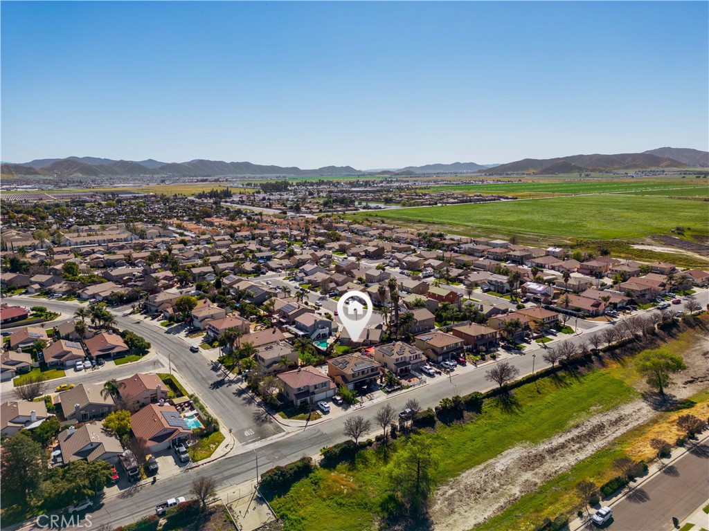 3807 Seattle Street Hemet, CA 92545 - Photo 36 of 37 an aerial view of a city with lots of residential buildings and mountain view in back